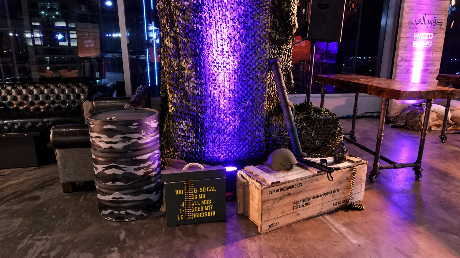 Invasion lounge with camouflage drums, ammo crates and purple lighting