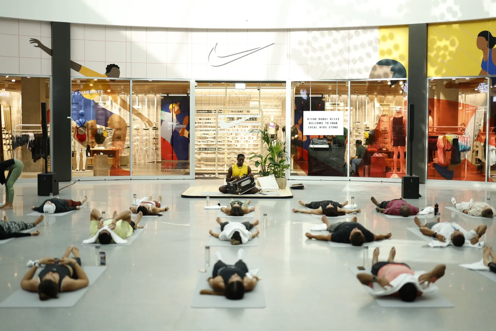 Participants lying in savasana in front of the Nike store
