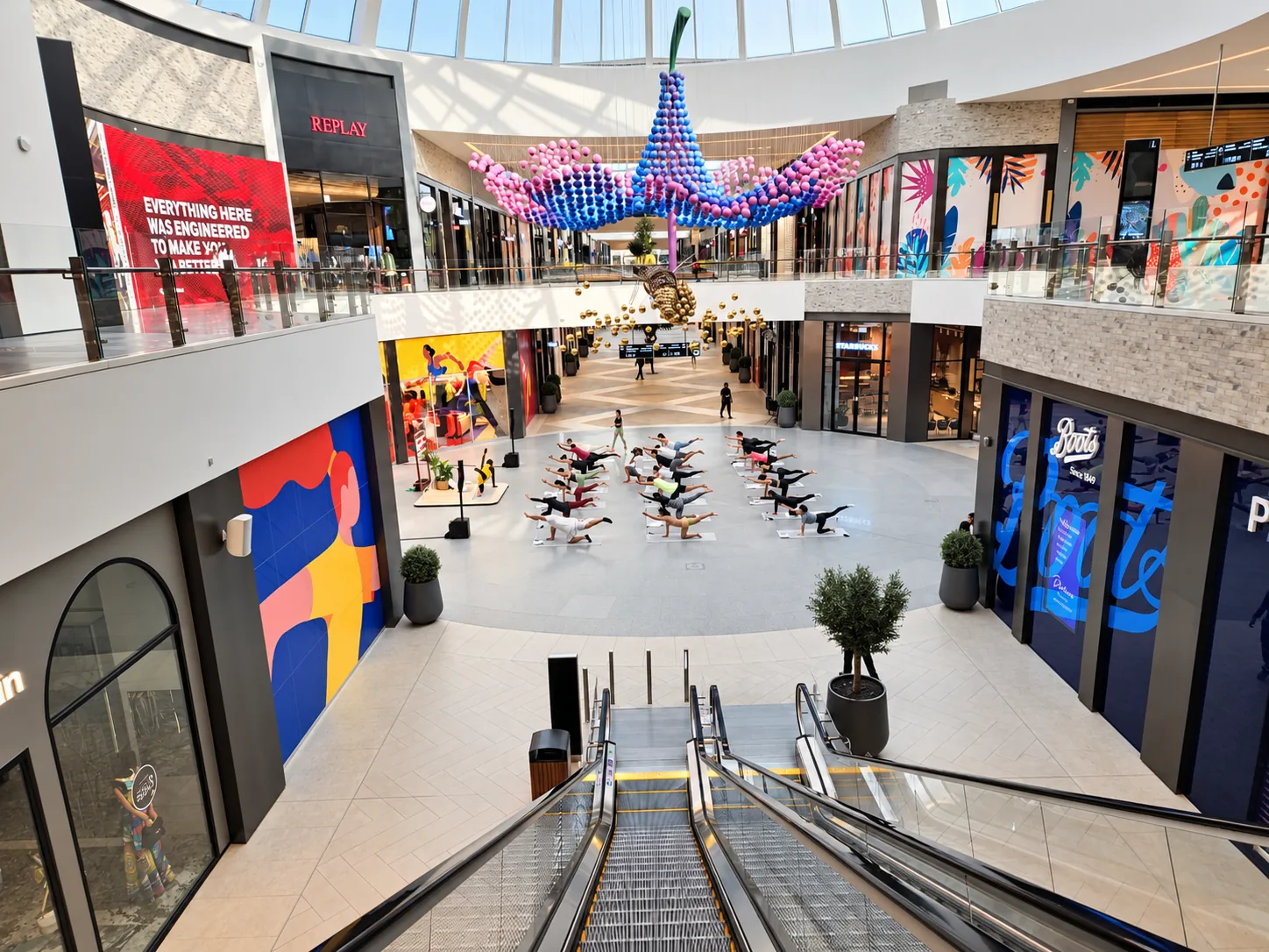 Wide view down the mall atrium to the yoga session below