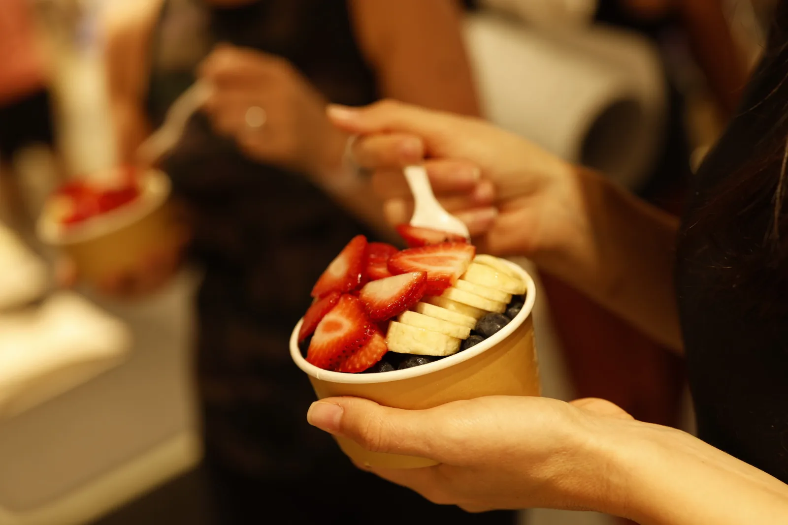Guest holding a fresh fruit bowl after the session