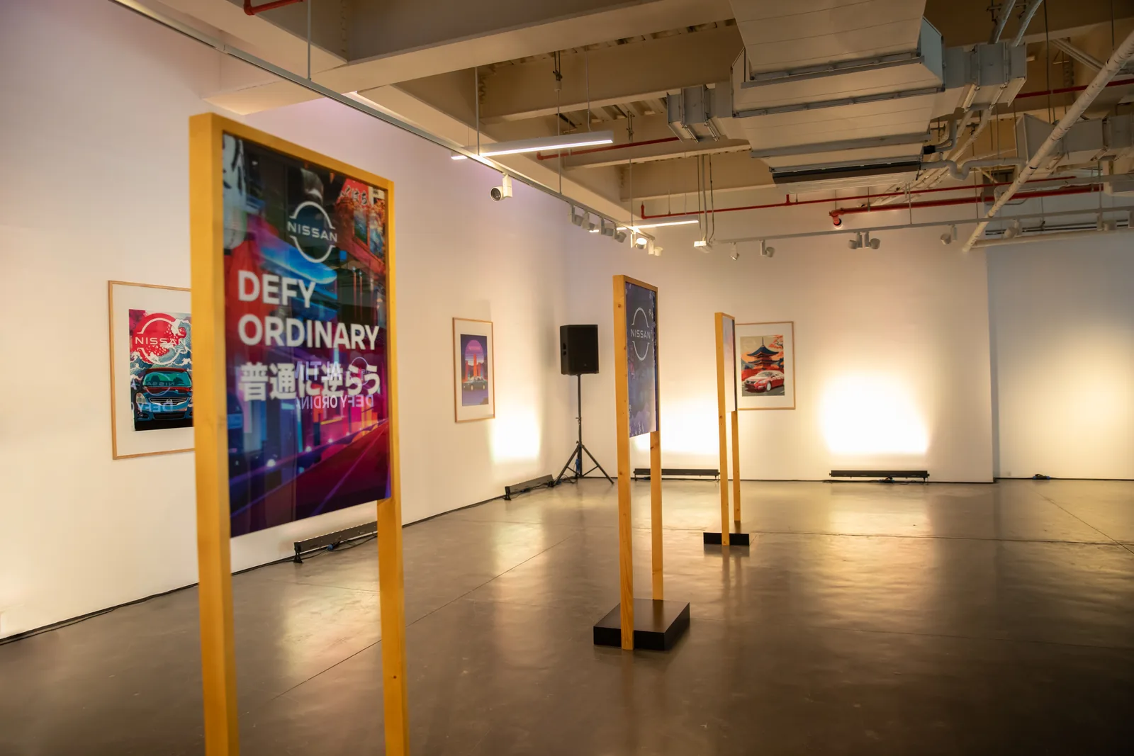 Defy Ordinary AR gallery with framed artworks on easels
