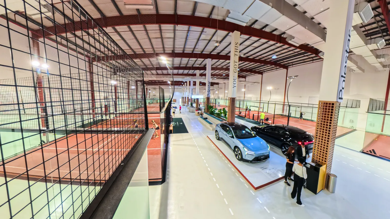 Polestar cars lined between padel courts