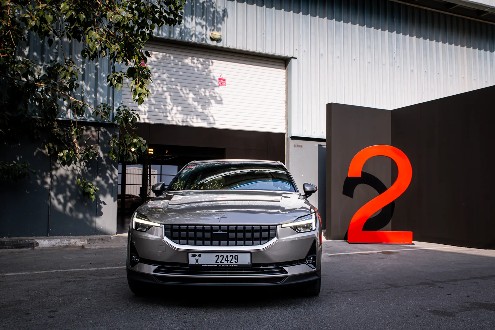 Polestar 2 in front of a giant red 2 at the entrance