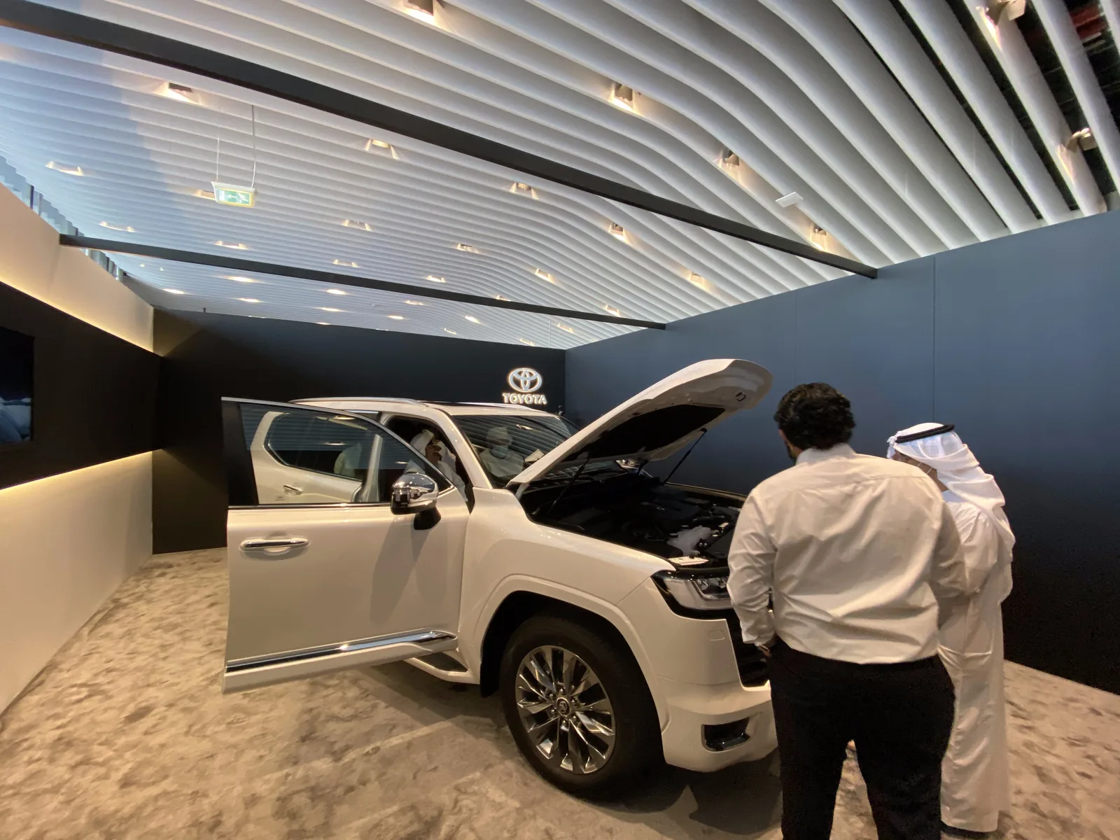Guests inspecting the engine in the showroom pod